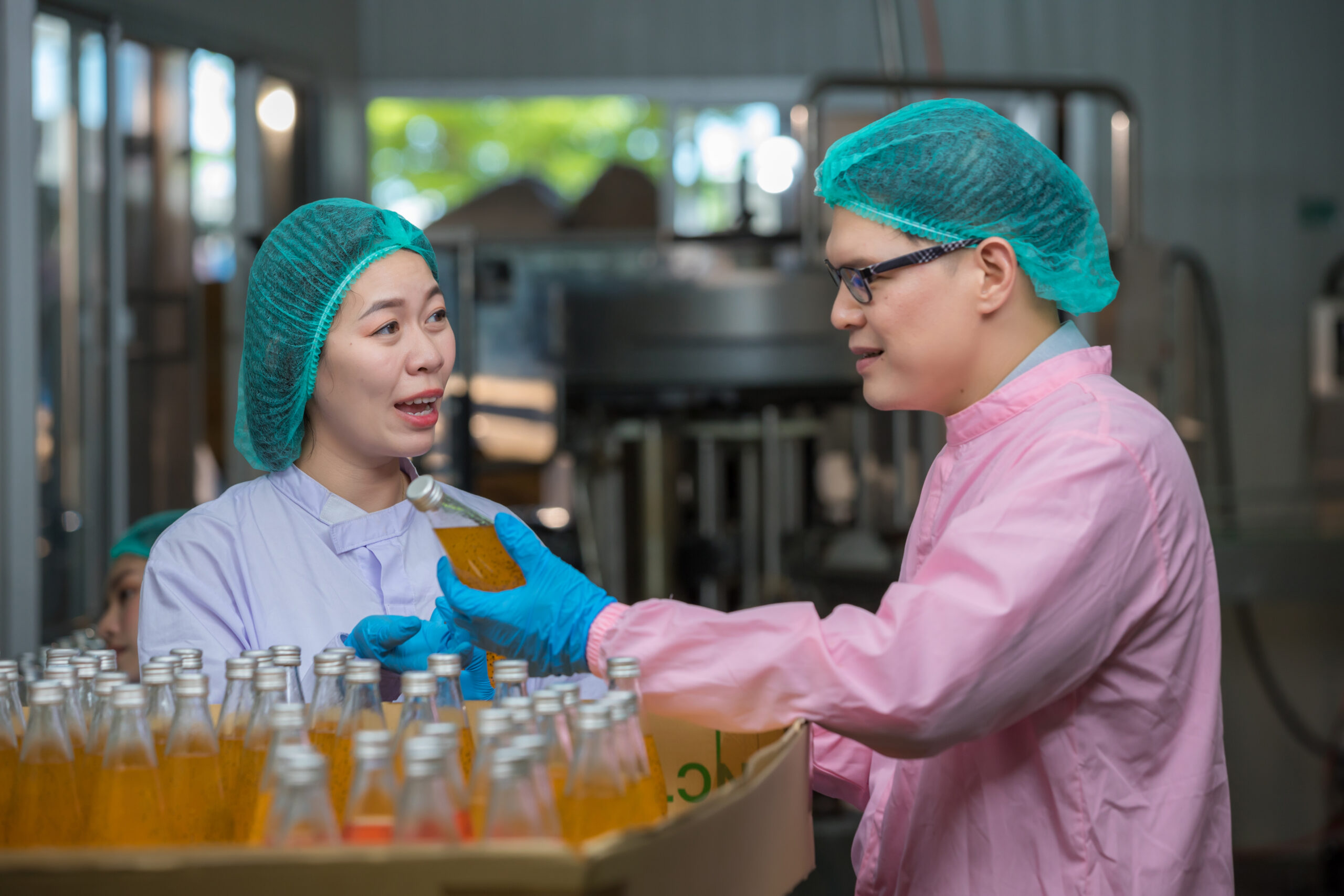 Two food manufacturing employees working together